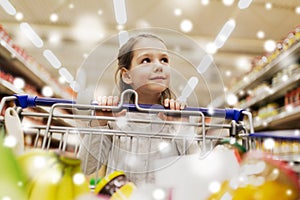 Girl with food in shopping cart at grocery store