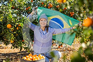 Girl football fan waving Brazil flag during lemons harvest