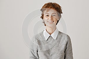 Girl fought her way in subway and looks like mess. Portrait of charming redhead woman with messy hair and untidy look