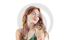 Girl in a freckle smiles a beautiful smile. White background. Slow motion