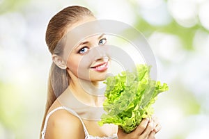 Girl with a fresh green lettuce leaf