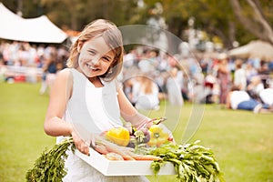 Girl With Fresh Produce Bought At Outdoor Farmers Market photo