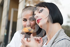 Girl friends with blueberry muffin in paris, france