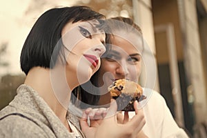 Girl friends with blueberry muffin in paris, france