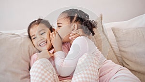 Girl, friends or children whisper secret to best friend on home sofa while relax together on play date. Communication