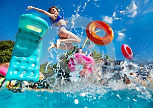 Girl and friends dive in swim pool splash to water