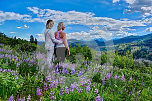 Girl friends hiking in meadows full bloom.