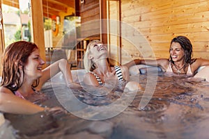 Girl friends relaxing in a hot tub while on a vacation