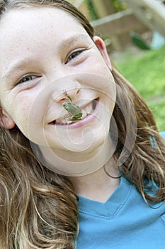 Girl with frog on nose