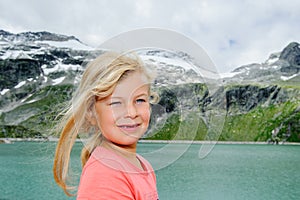 Girl in front of glacial lake and mountains