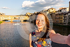 Girl in front of the Ponte Vecchio in Florence, Italy in summer