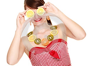 Girl in fruit necklace covering eyes with lemon