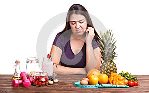 Girl with fruit on the table on a white isolated background