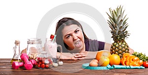 Girl with fruit on the table on a white isolated background