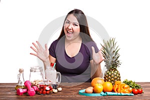 Girl with fruit on the table on a white isolated background