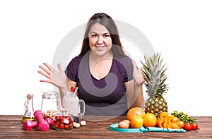 Girl with fruit on the table on a white isolated background