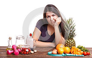 Girl with fruit on the table on a white isolated background