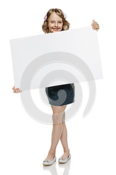 Girl in full length holding blank whiteboard