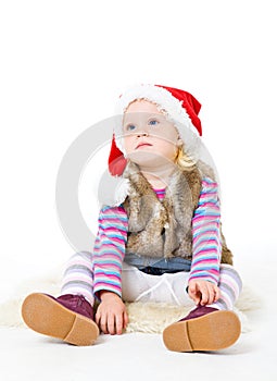 Girl in a fur jacket and a red Santa's cap