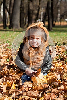 Girl in a fur jacket sits