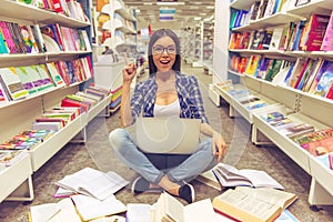 Girl with gadget at the bookshop