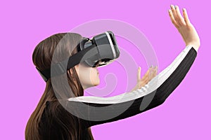 Girl gamer in VR glasses isolated on a pink background