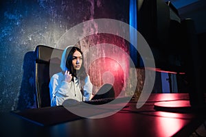 Girl gamer wearing headphone playing network games preparing to participate in international competitions in esports