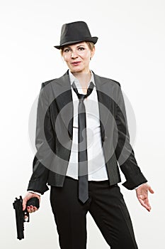 Girl gangster holding a gun. Classic suit and hat.