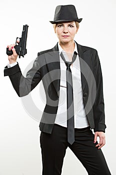 Girl gangster holding a gun. Classic suit and hat.