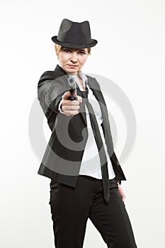 Girl gangster holding a gun. Classic suit and hat.