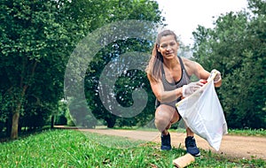 Girl with garbage bag doing plogging