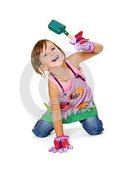 Girl in garden clothes with garden scoop