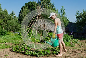 Girl garden watering can stick tower beans