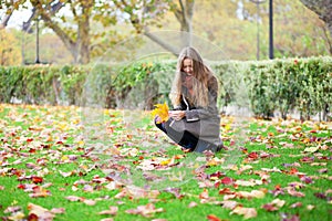 Girl gathering autumn leaves