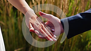 The girl gently and gently touches the palm of her boyfriend.