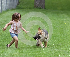 Girl with German Shepherd Dog puppy at park