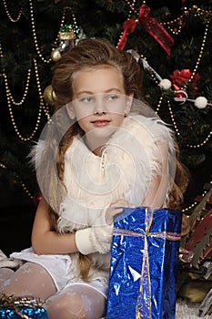 Girl with a gift in blue packaging