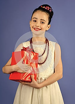 Girl with a gift. Small girl with shopping package, black friday. Boxing day, holiday celebration and party. Child girl