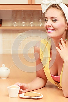 Girl with gingerbread cookies drinking tea coffee.