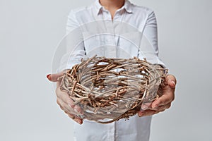 Girl gives a nest of twigs