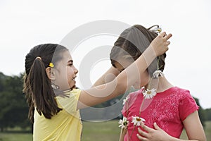 Girl Giving Friend Daisy Chain