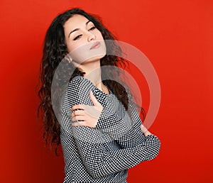 Girl glamour portrait on red, long curly hair