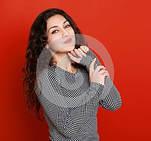 Girl glamour portrait on red, long curly hair