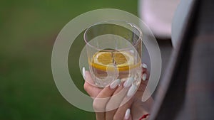 Girl with a glass with an alcoholic drink or cocktail. Orange water, soda, tonic
