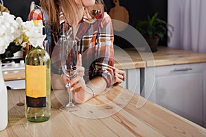 Girl with a glass and a bottle of white wine.