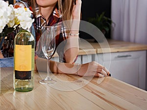 Girl with a glass and a bottle of white wine.