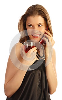 Girl with a glass of wine talking on the phone