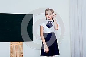 Girl in glasses at the Blackboard in a class lesson