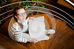 The girl in glasses with a book in their hands