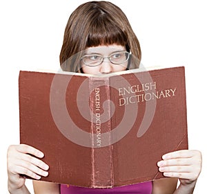 Girl with glasses reads English Dictionary book